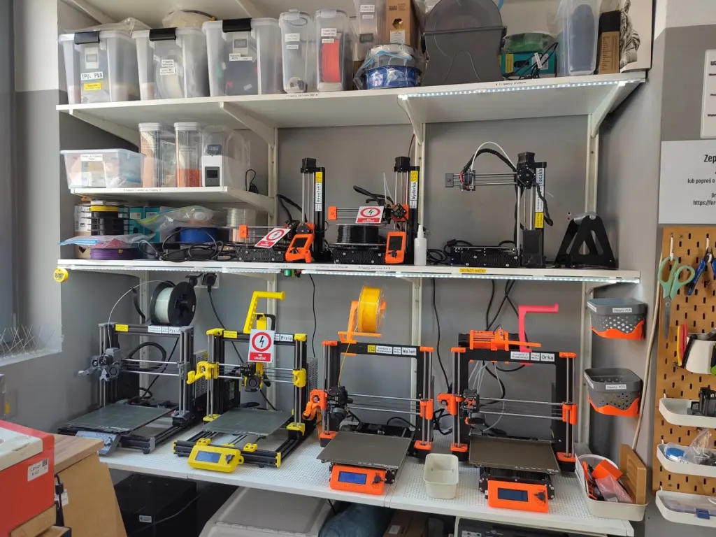 Depicts the 3D printer farm at Hackerspace Wrocław. 4 × Prusa MK3S+ and 3 × Prusa mini