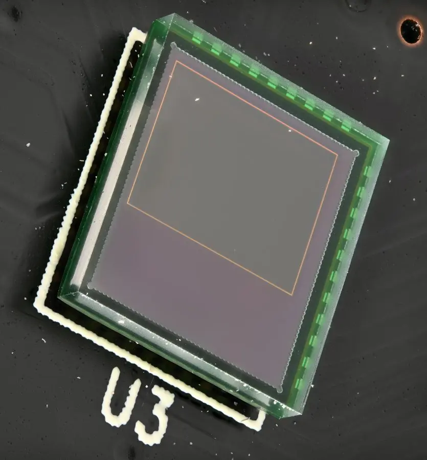 Unknown CMOS image sensor, probably OmniVision, in a glass chip-scale package. The top cover glass is visible,